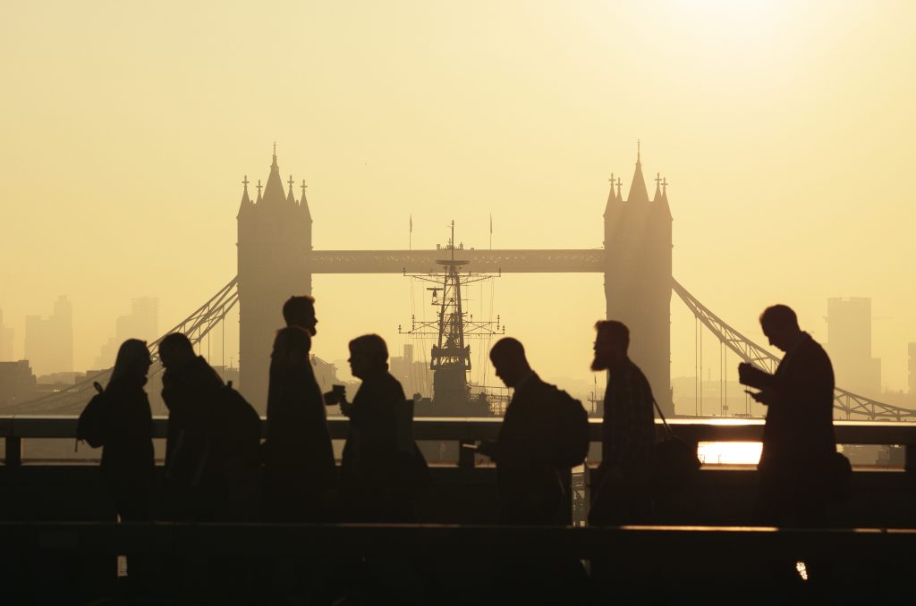 People in silhouette against London Bridge backdrop