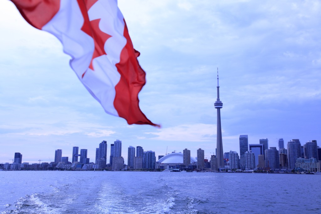 Canada flag against Toronto skyline