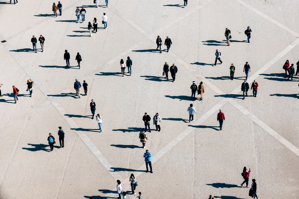 Aerial view of people walking across plaza