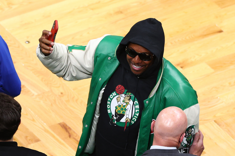 Former Boston Celtics player Paul Pierce celebrates on the sidelines after a basketball game.