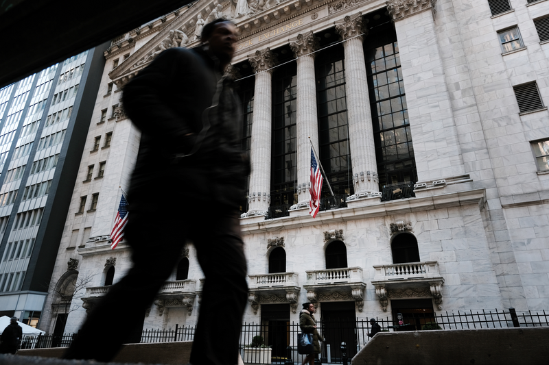 People walk by the New York Stock Exchange.