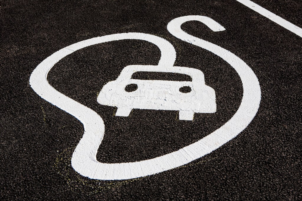 Electric car charging point logo on ground