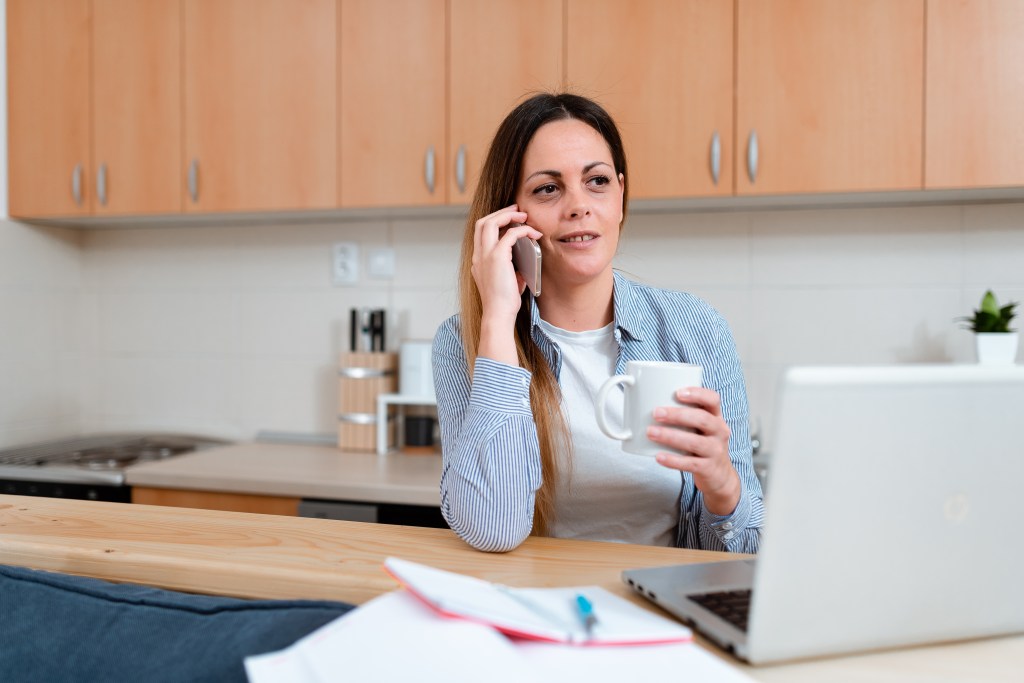 Woman on phone looking at computer