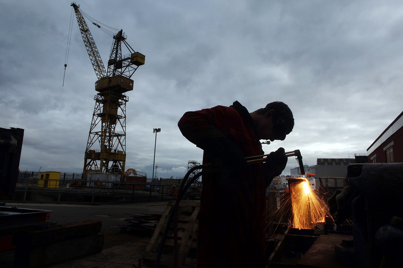 A steel worker is welding.