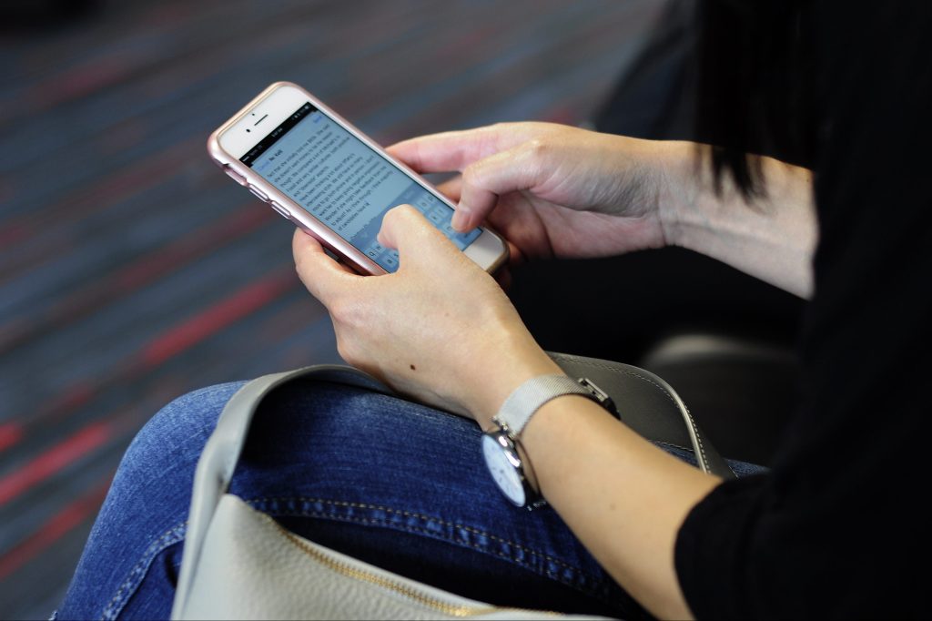 Woman using smartphone to send email
