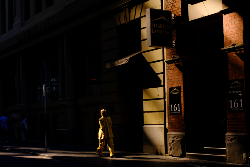 A person walks through a patch of sunlight in Australia