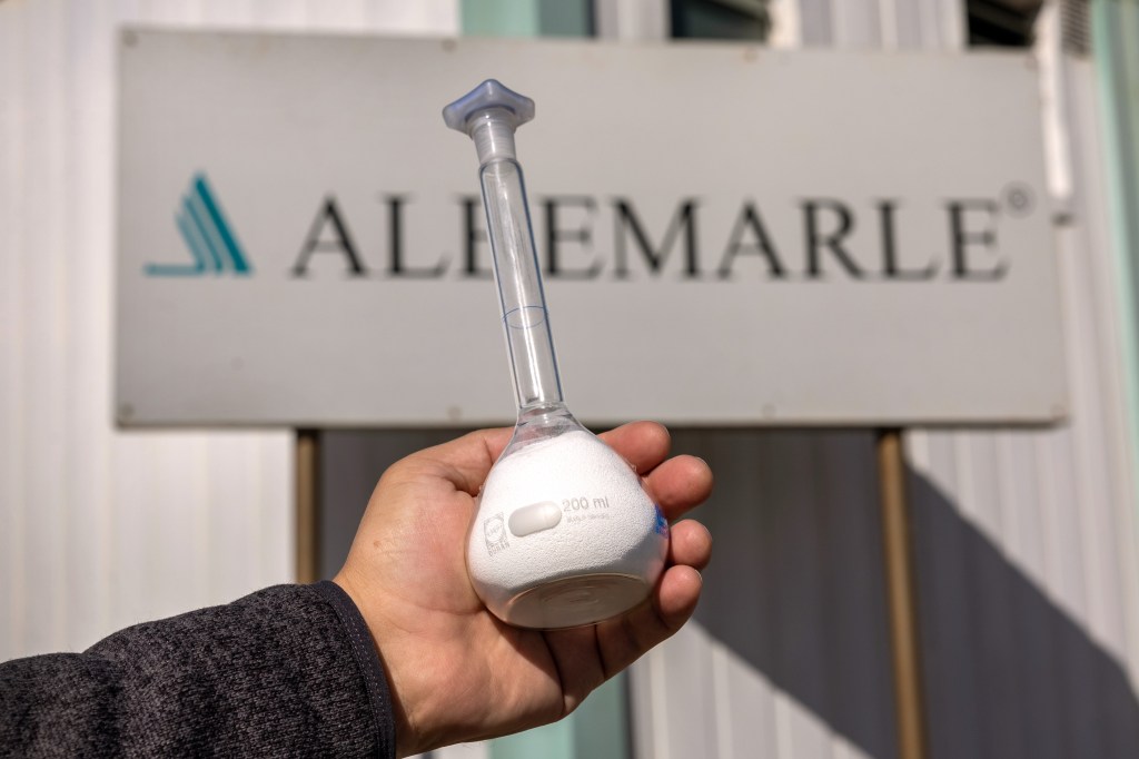 Picture of Albemarle Corp. sign and a vial of lithium.