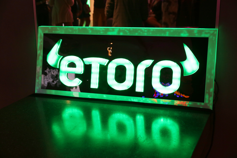 a neon sign of the eToro logo
