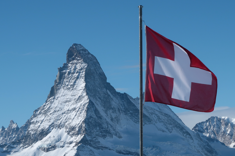 Swiss flag flies near Matterhorn mountain