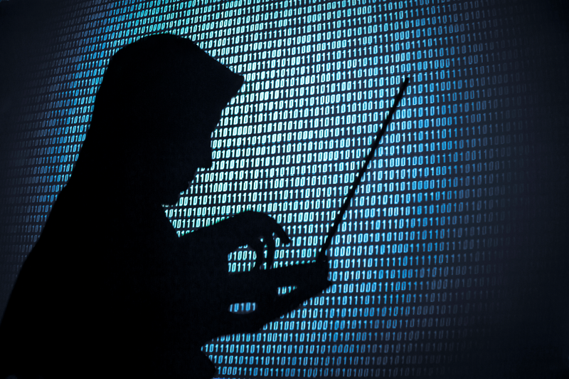 Computer hacker silhouette. Blue binary code background
