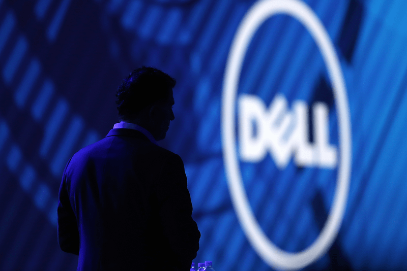 Man standing in front of the DELL logo.