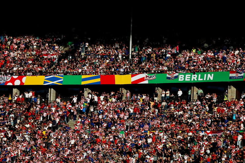 Fans of Croatia and Spain drape flags of UEFA Euro 2024 Germany, Berlin signage during the UEFA EURO 2024 group stage match.