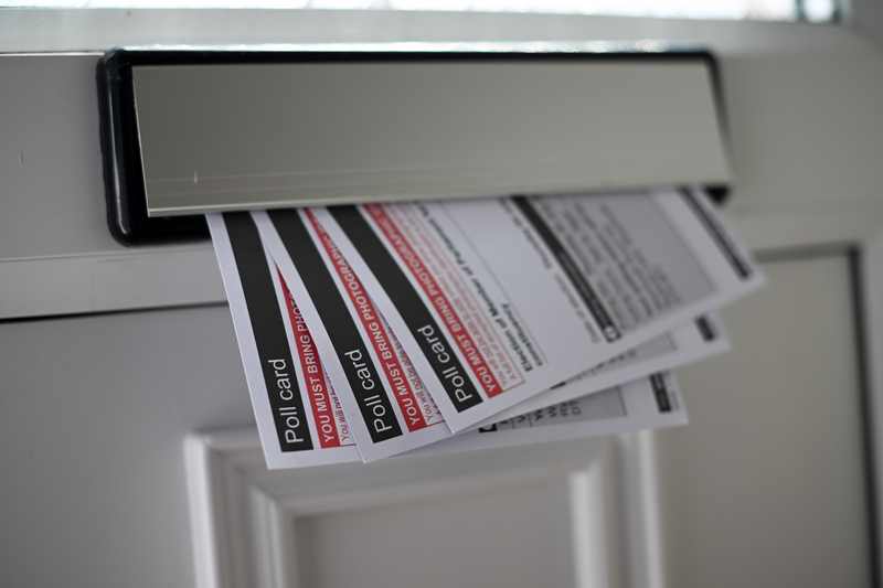 Polling cards for the general election are seen delivered to a residential letterbox, on June 10, 2024.