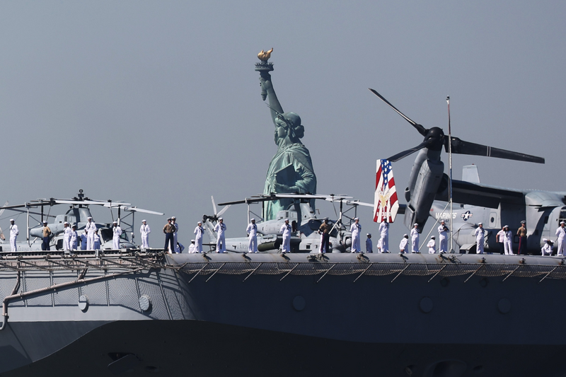 The USS Bataan (LHD-5) sails past the Statue of Liberty as it arrives with the Parade of Ships into New York Harbor during the start of the 36th annual Fleet Week on May 22, 2024 in New York City.