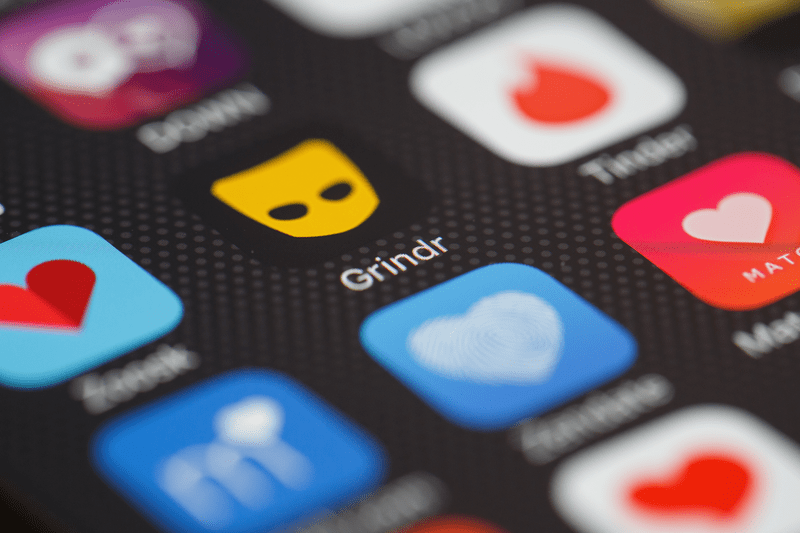 The "Grindr" app logo is seen amongst other dating apps on a mobile phone.