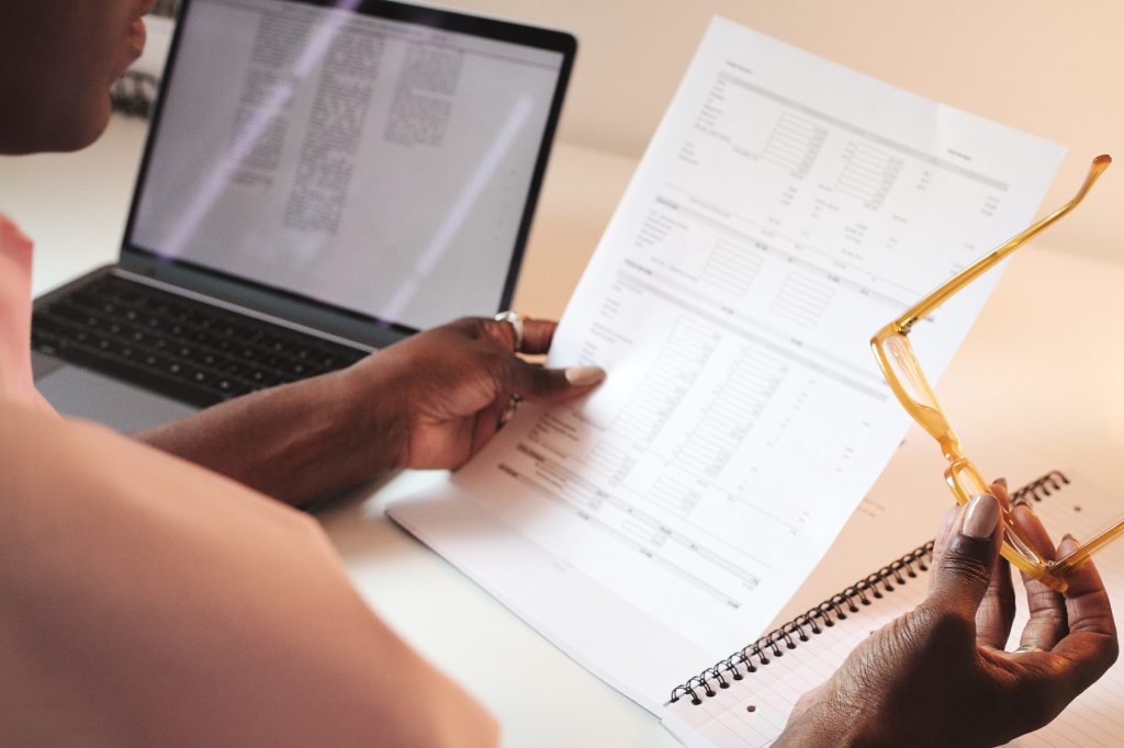 Hands, accountant and woman with document for finance, tax or audit in business office.