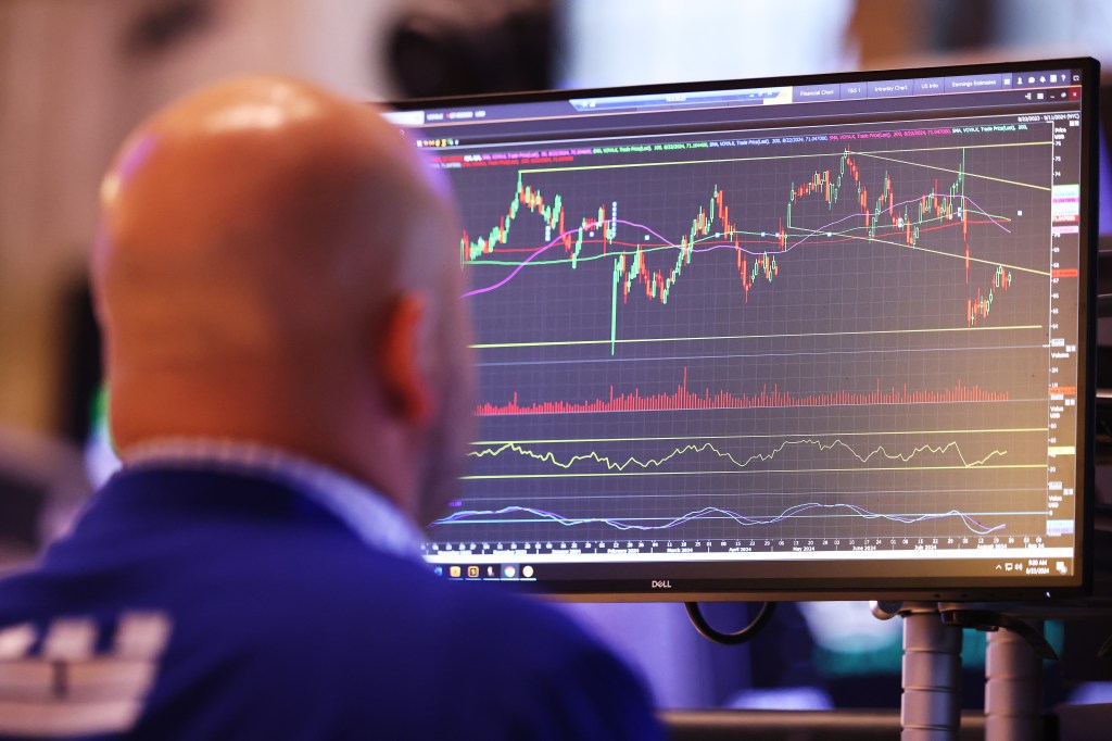 Image of a man looking at a computer screen of trade data.