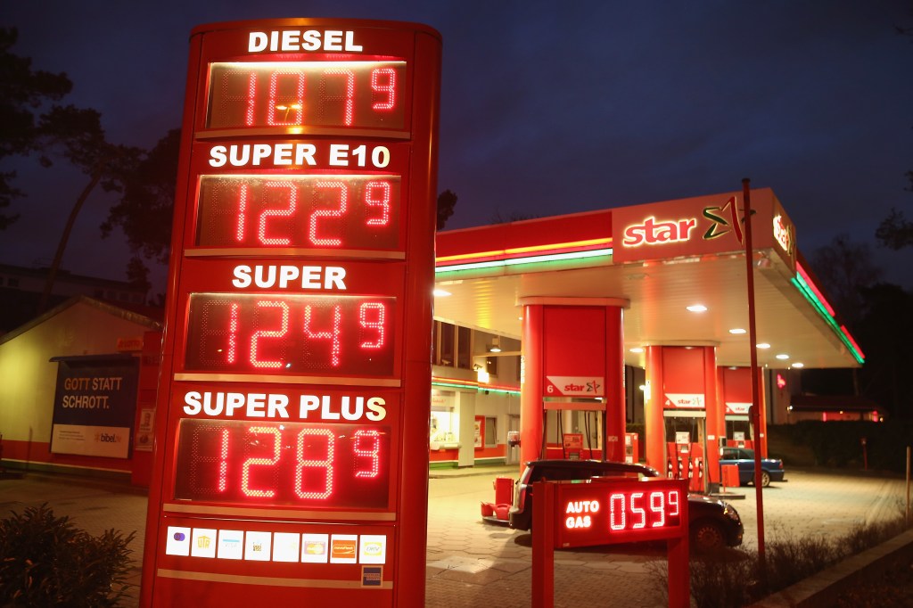 Sign showing various gasoline prices, depending on unleaded, leaded, etc., at a petrol station in Europe.