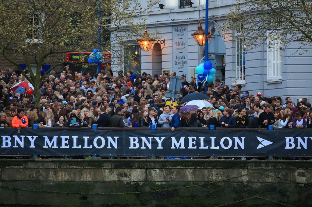 Image of a BNY Mellon sign during a boat race in London in 2014.