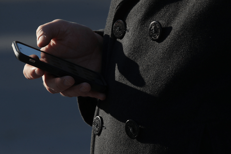 A man checks his cell phone.