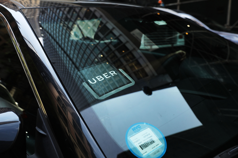 Close up of an Uber car that waits for a client.