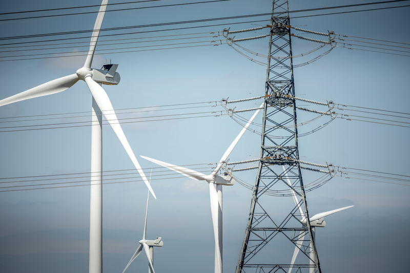 Wind turbines generate power and pylons carry electricity near the Keadby Power Station.