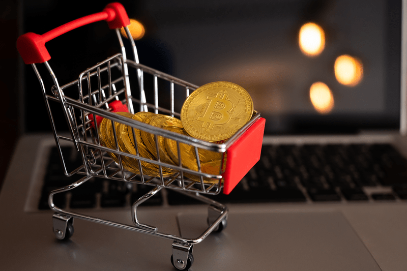 Bitcoin token in a trolley on laptop