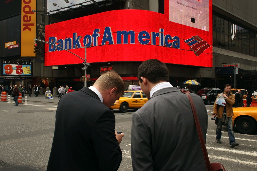 Image of Bank of America signage with two men standing in front of it in NYC.