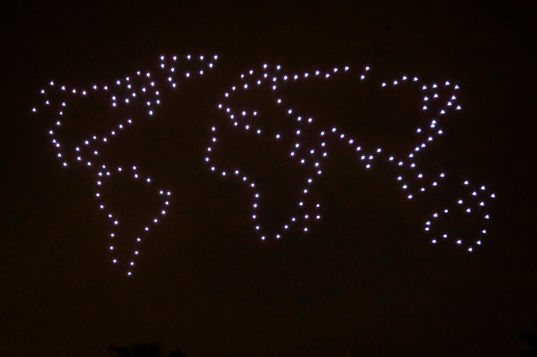 Drones outlining a world map.