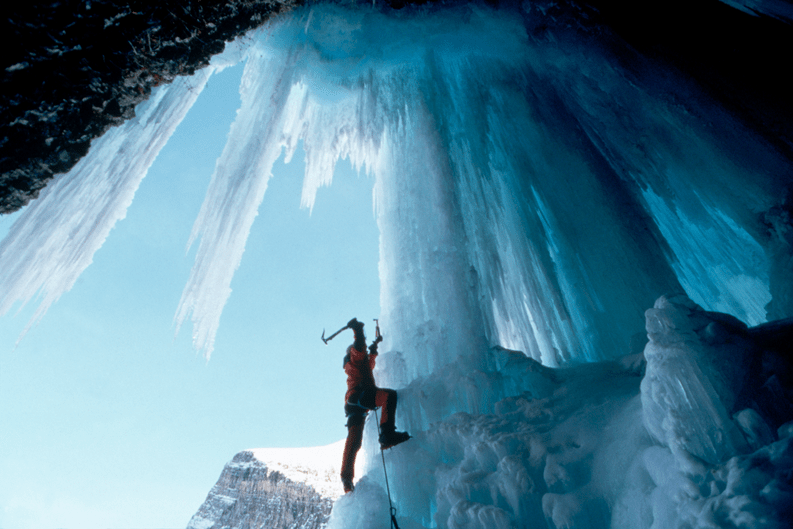 Ice climbing up frozen waterfall.