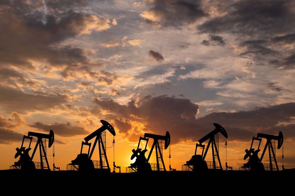 Oil field with rigs at sunset. World Oil Industry