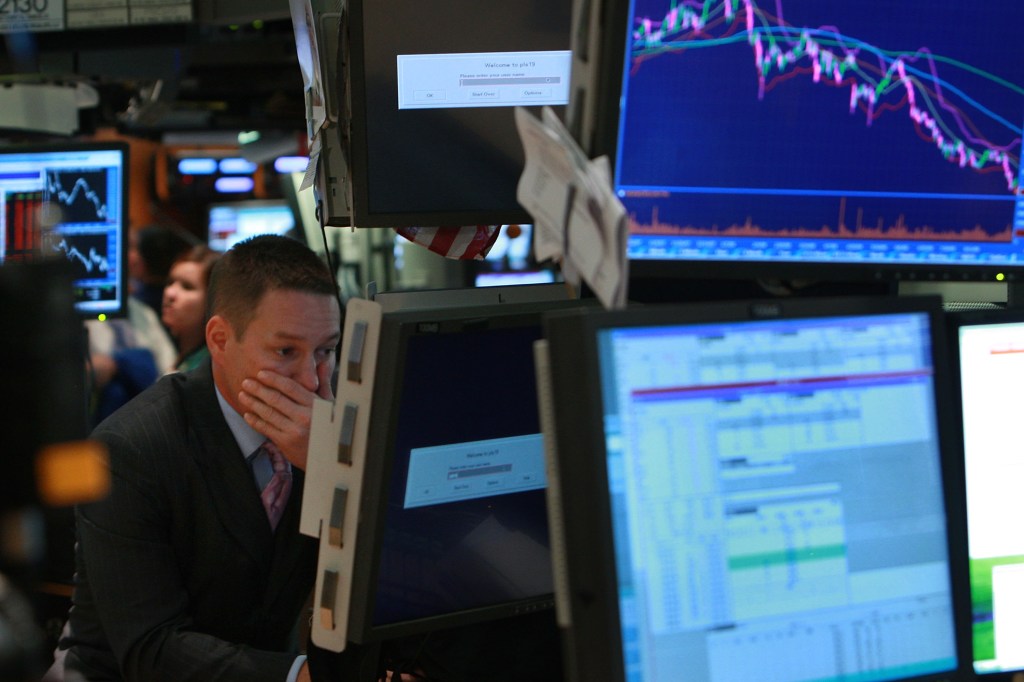 Image of a trader at a terminal reviewing electronic trading data.