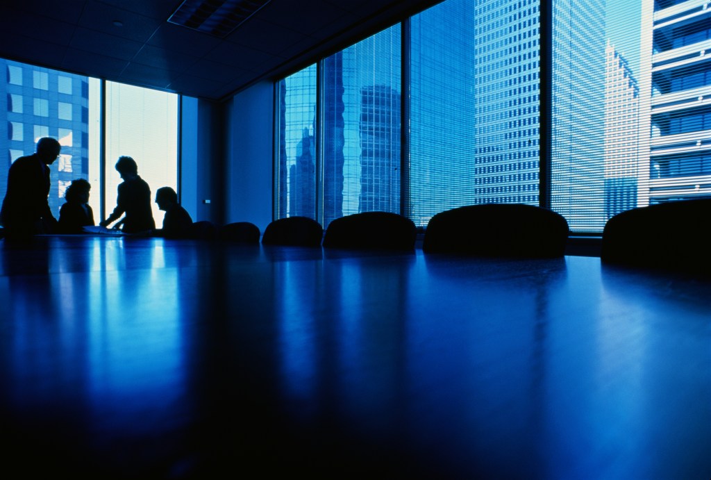 Executives at end of conference table