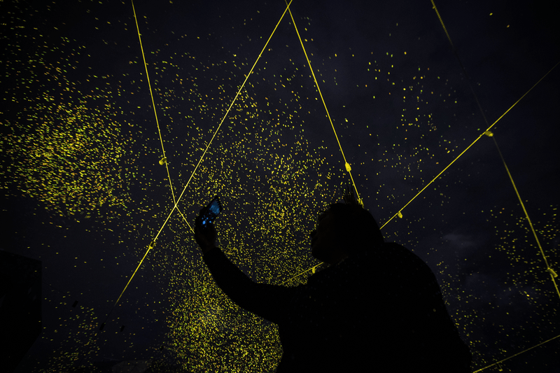 People enjoy SPARK an installation by artist Daan Roosegaarde at Federation Sqaure.