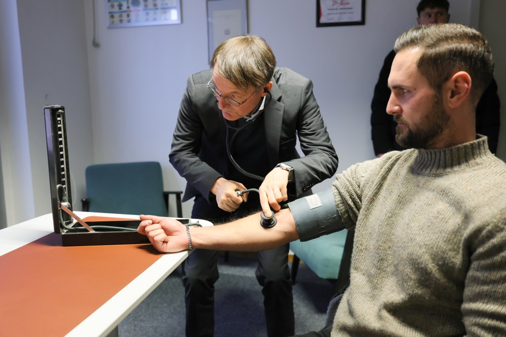 Image of a person getting his blood pressure taken at a medical center.