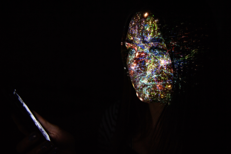 A virtual map of the internet is projected onto a woman.