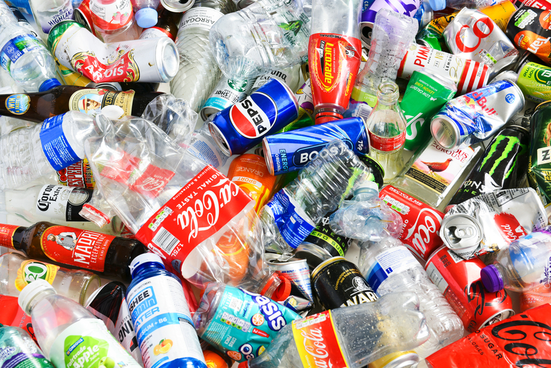 A view of a mixed waste recycling bin with loose plastic and cans ready for recycling in Morden, London, United Kingdom.