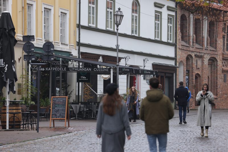 People walk in the historic city center in Vilnius, Lithuania.